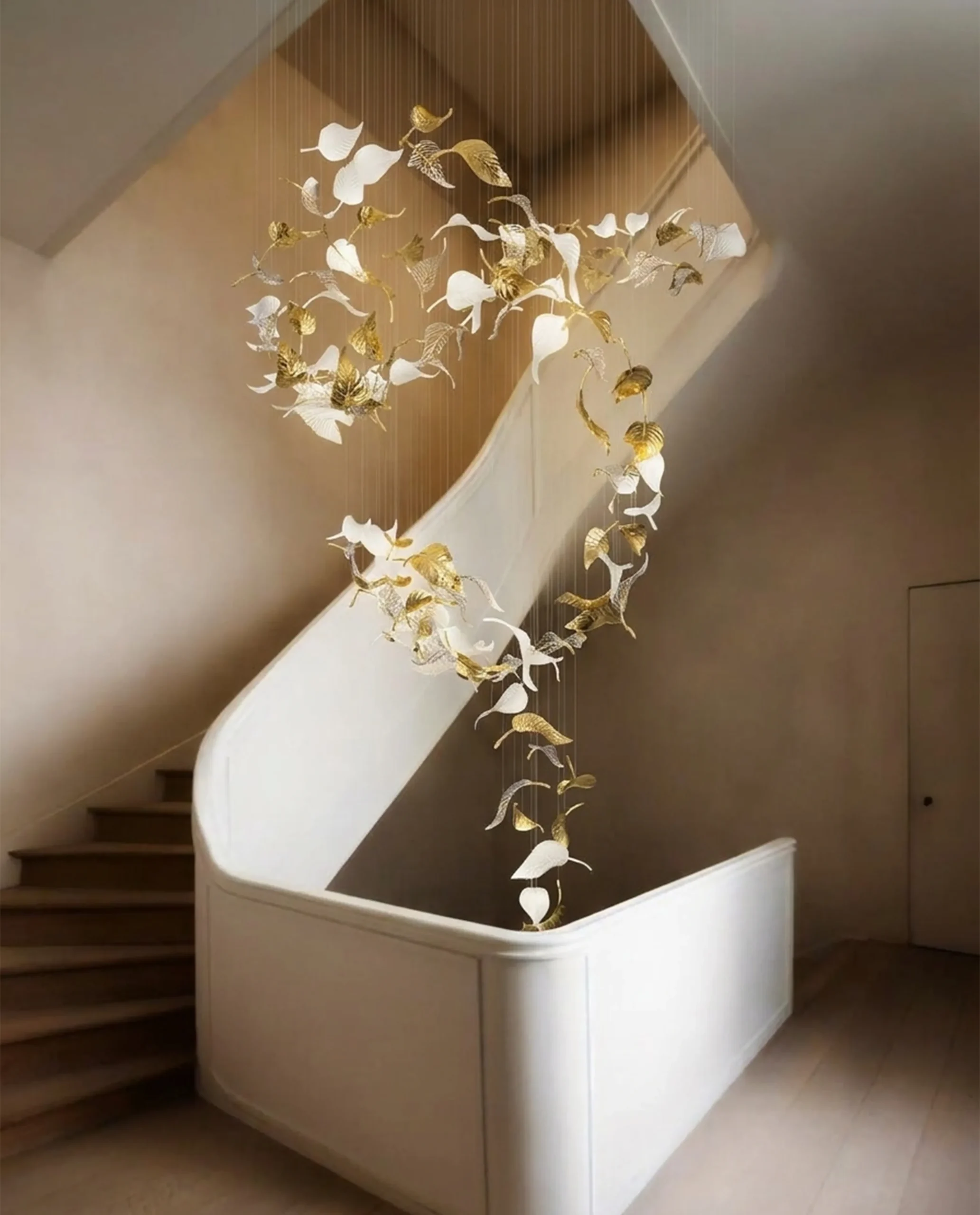 Amara chandelier cascading leaf formation in stairwell