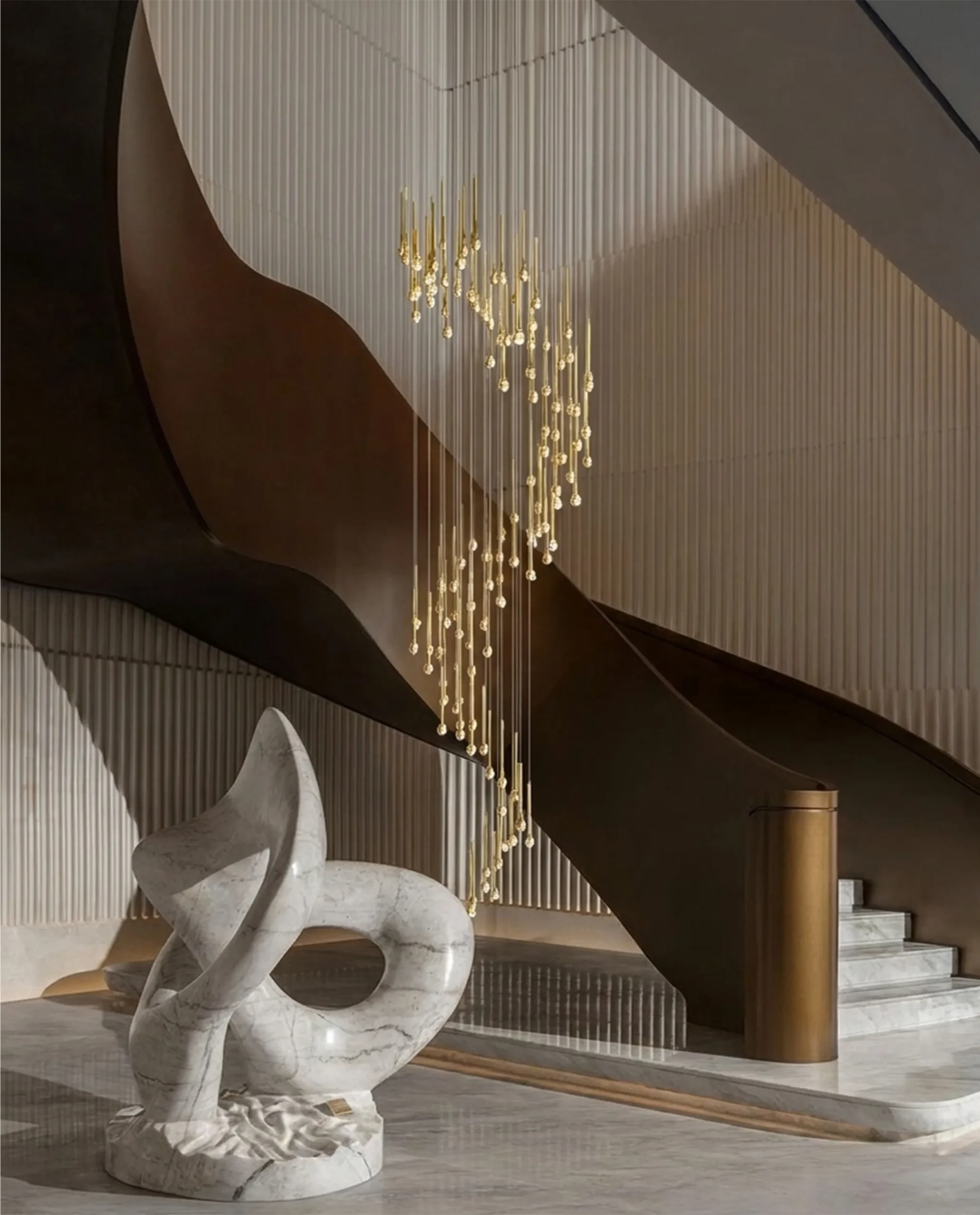 Gazelle chandelier installed in luxury stairwell with curved wall