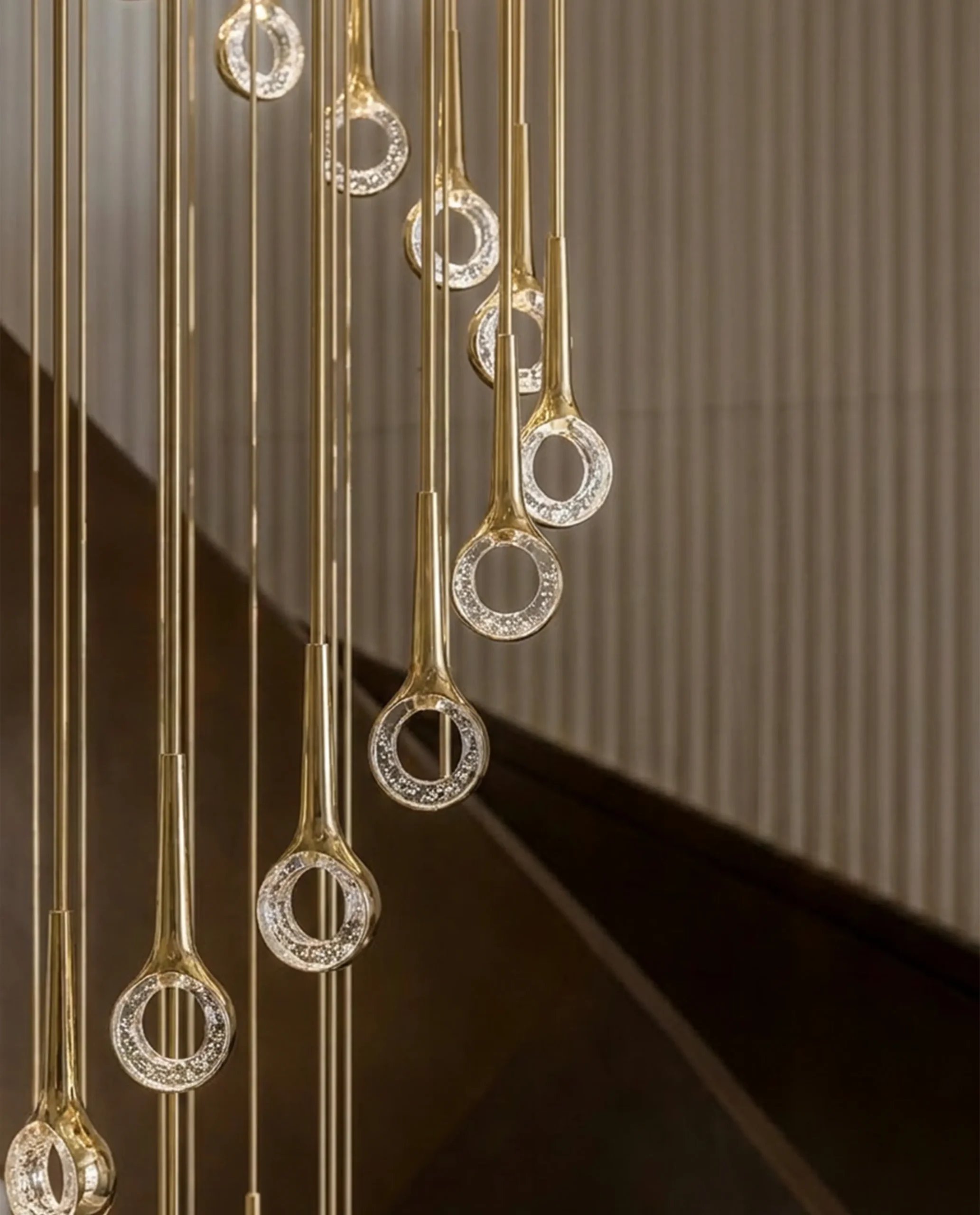 Gazelle chandelier slim gold rod suspension close-up